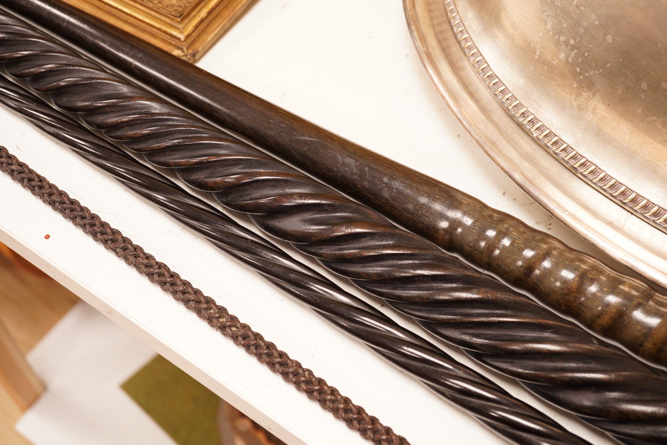 Four assorted canes to include a tapering horn example, a woven example, etc